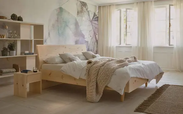 Helles Schlafzimmer mit Massivholzbett, gemütlicher Bettwäsche und großer Fensterfront.